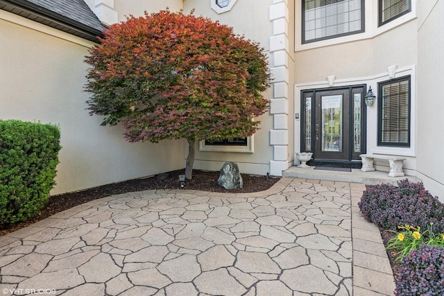 24650 Lincolnway St, Plainfield, IL 60544 - view of exterior entry featuring stucco siding and a patio area