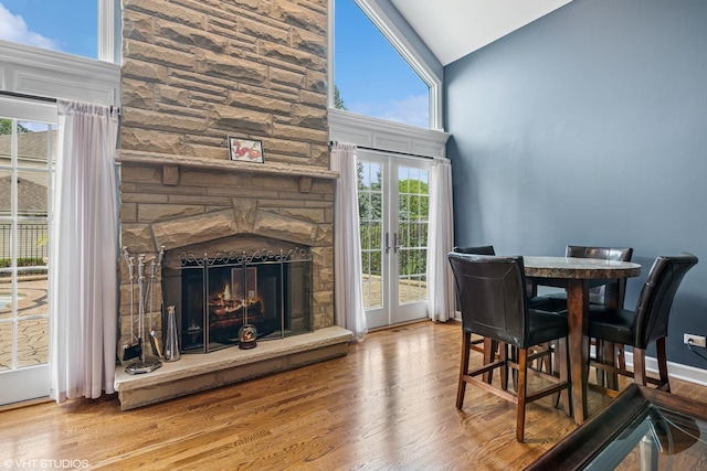 24650 Lincolnway St, Plainfield, IL 60544 - dining room featuring wood finished floors, high vaulted ceiling, and a fireplace
