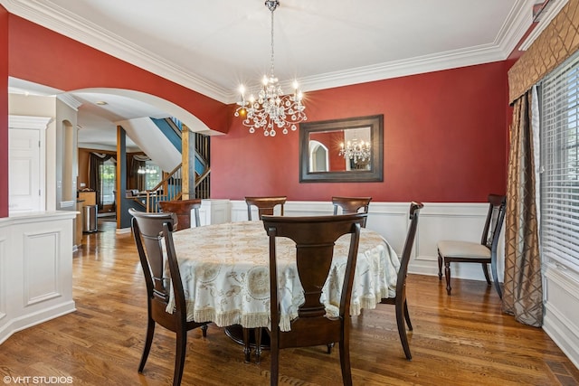 24650 Lincolnway St, Plainfield, IL 60544 - dining room with stairs, ornamental molding, wood finished floors, plenty of natural light, and arched walkways