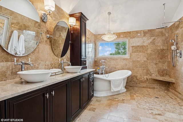 24650 Lincolnway St, Plainfield, IL 60544 - bathroom with tile walls, a freestanding bath, double vanity, tiled shower, and a chandelier