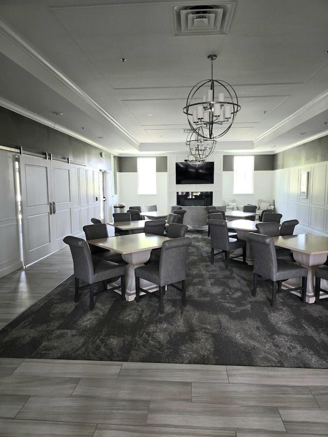 2003 Magenta Ln, Algonquin, IL 60102 - dining room with a chandelier, healthy amount of natural light, a raised ceiling, and wood finished floors