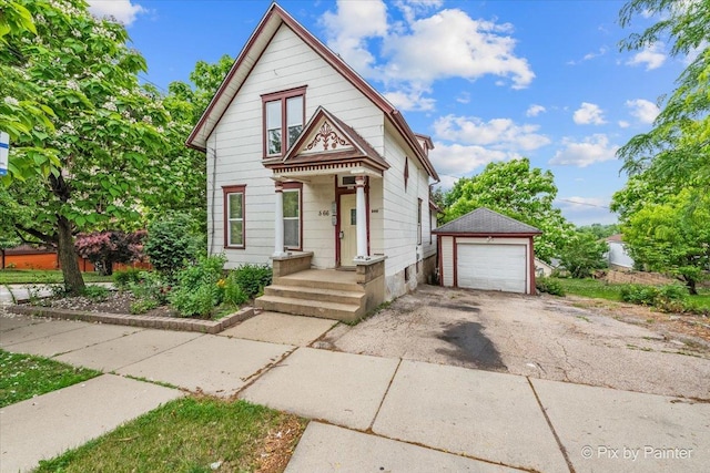 566 Raymond St, Elgin, IL 60120 - victorian-style house featuring asphalt driveway, an outbuilding, and a detached garage