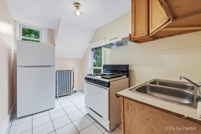 566 Raymond St, Elgin, IL 60120 - kitchen with white appliances, radiator, plenty of natural light, under cabinet range hood, and vaulted ceiling