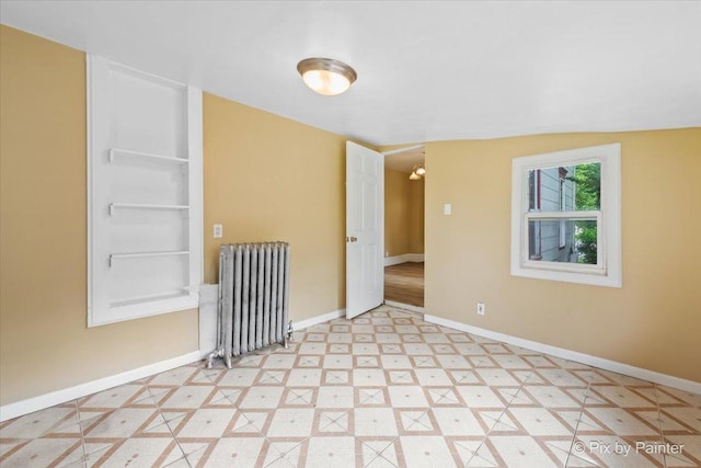 566 Raymond St, Elgin, IL 60120 - unfurnished room featuring radiator and baseboards