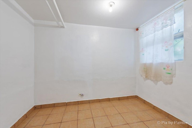 566 Raymond St, Elgin, IL 60120 - tiled empty room with baseboards