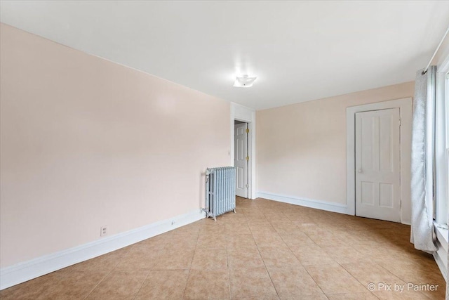 566 Raymond St, Elgin, IL 60120 - spare room with radiator and light tile patterned floors