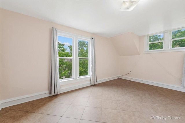 566 Raymond St, Elgin, IL 60120 - bonus room with healthy amount of natural light, lofted ceiling, and light tile patterned flooring