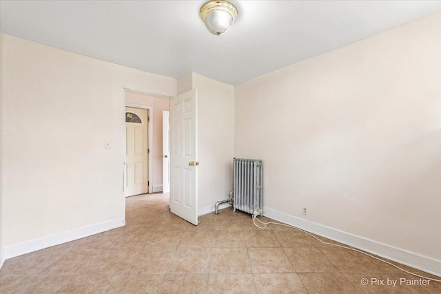 566 Raymond St, Elgin, IL 60120 - unfurnished room with radiator heating unit and baseboards