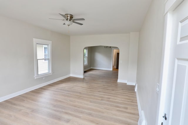 507 Grant Ave, Joliet, IL 60433 - spare room with arched walkways, a ceiling fan, and light wood-style flooring