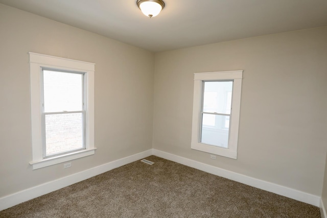 507 Grant Ave, Joliet, IL 60433 - empty room with dark colored carpet and baseboards