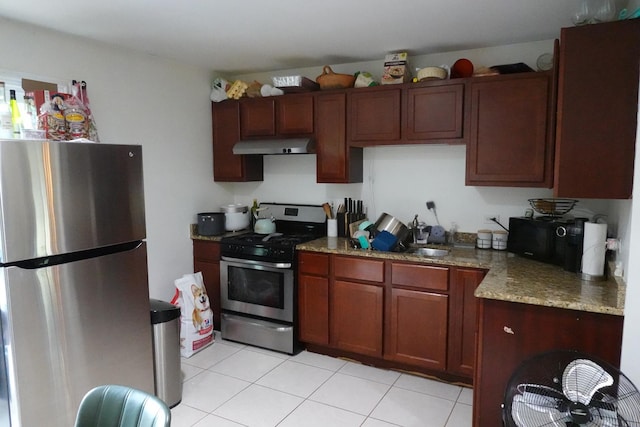 505 Woodmoor Dr, Round Lake Beach, IL 60073 - kitchen with stainless steel appliances, under cabinet range hood, light tile patterned floors, and light stone countertops