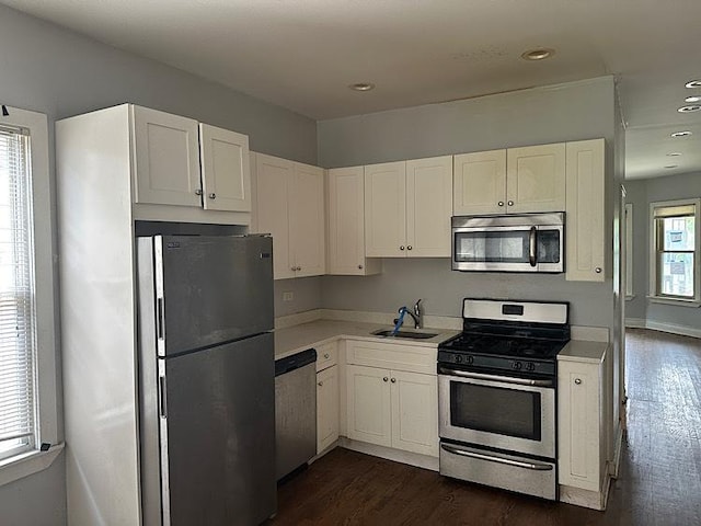 4131 N Monticello Ave, Chicago, IL 60618 - kitchen with stainless steel appliances, dark wood finished floors, light countertops, white cabinets, and recessed lighting