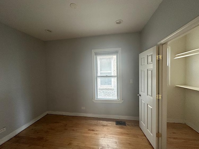 4131 N Monticello Ave, Chicago, IL 60618 - unfurnished bedroom featuring wood finished floors and a closet