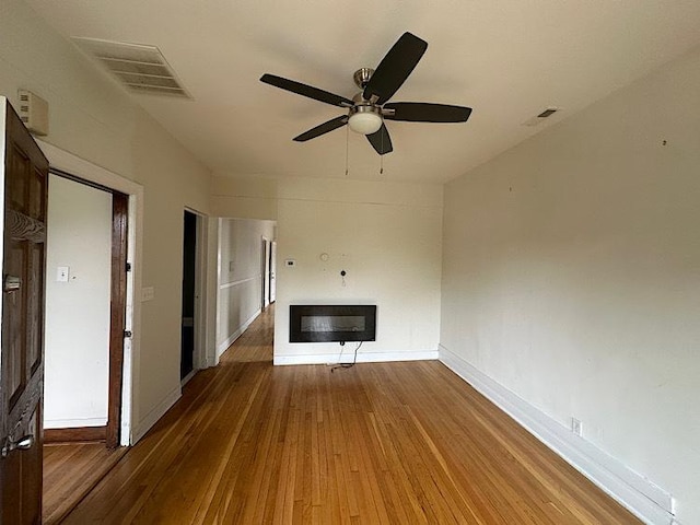 4131 N Monticello Ave, Chicago, IL 60618 - unfurnished living room featuring hardwood / wood-style floors and a ceiling fan