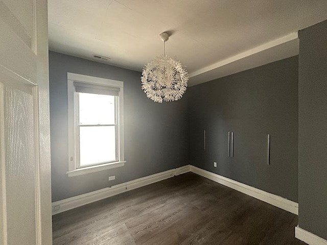 4131 N Monticello Ave, Chicago, IL 60618 - empty room featuring a chandelier and dark wood-style flooring