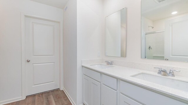 3706 Stockton Dr, Joliet, IL 60436 - bathroom featuring double vanity, a shower with shower door, and wood finished floors