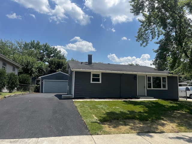 805 Monroe Ave, Carpentersville, IL 60110 - ranch-style house featuring a garage, an outbuilding, a front yard, and a chimney