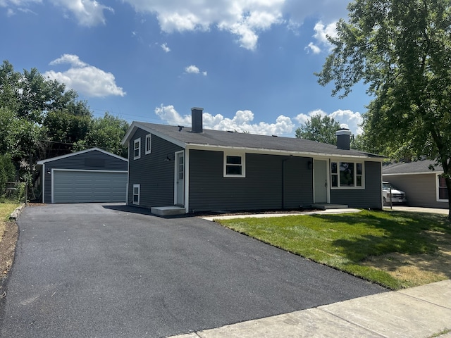 805 Monroe Ave, Carpentersville, IL 60110 - ranch-style home with an outdoor structure, a detached garage, a chimney, and a front lawn