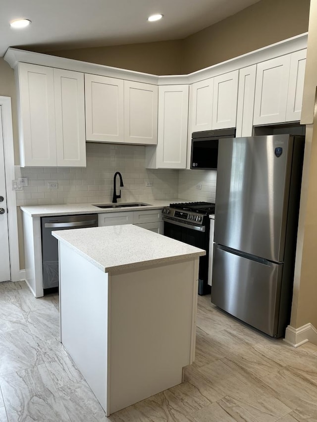 805 Monroe Ave, Carpentersville, IL 60110 - kitchen with stainless steel appliances, decorative backsplash, a kitchen island, light countertops, and recessed lighting