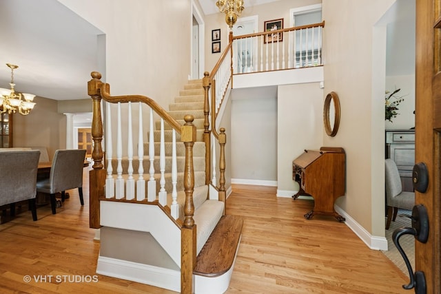 235 Valley Rd, Trout Valley, IL 60013 - staircase with wood finished floors and a chandelier