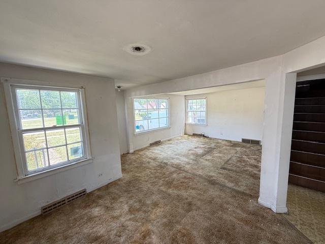 2025 Marshall Pkwy, Waukegan, IL 60085 - unfurnished living room featuring healthy amount of natural light and carpet flooring