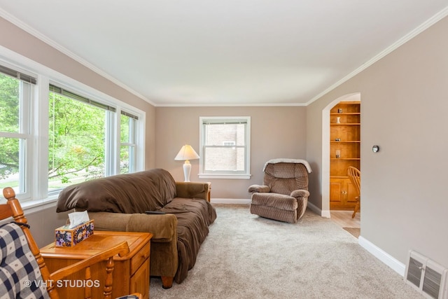 636 S 10th Ave, La Grange, IL 60525 - living area with crown molding, plenty of natural light, light colored carpet, and arched walkways