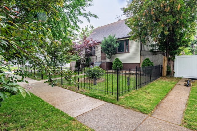 1502 N 34th Ave, Melrose Park, IL 60160 - view of front of property featuring a fenced front yard and roof with shingles