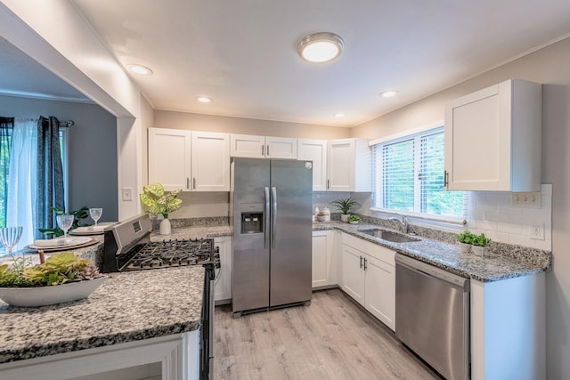 1502 N 34th Ave, Melrose Park, IL 60160 - kitchen featuring appliances with stainless steel finishes, light wood-style floors, white cabinets, light stone counters, and tasteful backsplash