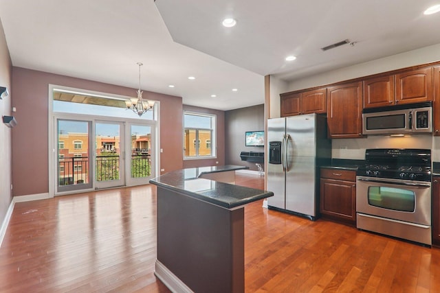 1200 N Foxdale Dr Unit 312, Addison, IL 60101 - kitchen featuring stainless steel appliances, dark countertops, wood finished floors, and recessed lighting