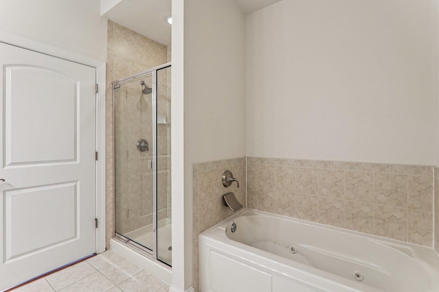 1200 N Foxdale Dr Unit 312, Addison, IL 60101 - full bathroom with a jetted tub, a shower stall, and tile patterned flooring