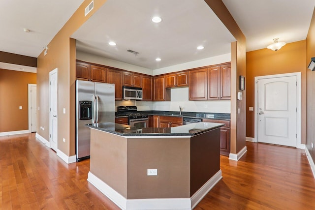 1200 N Foxdale Dr Unit 312, Addison, IL 60101 - kitchen featuring appliances with stainless steel finishes, a center island, wood finished floors, and recessed lighting