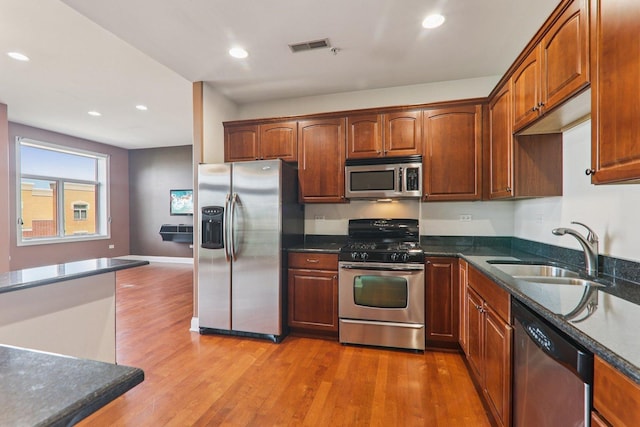 1200 N Foxdale Dr Unit 312, Addison, IL 60101 - kitchen featuring stainless steel appliances, light wood-type flooring, recessed lighting, and dark stone counters
