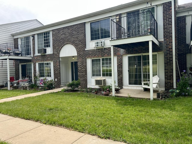704 Kiwanis Dr Unit 1, Freeport, IL 61032 - view of front of home with a balcony, brick siding, and a front lawn