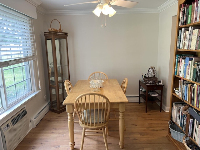 704 Kiwanis Dr Unit 1, Freeport, IL 61032 - dining room featuring baseboard heating, light wood-style floors, crown molding, a ceiling fan, and a wall mounted AC