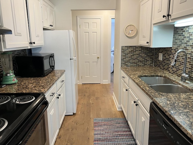 704 Kiwanis Dr Unit 1, Freeport, IL 61032 - kitchen featuring black appliances, white cabinetry, light wood finished floors, backsplash, and dark stone counters