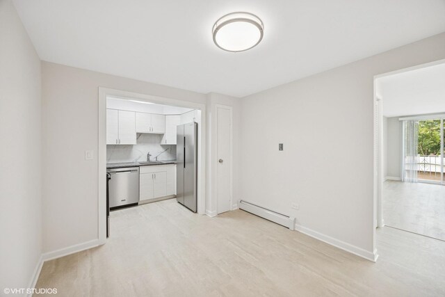 415 Wesley Ave Unit 45, Oak Park, IL 60302 - unfurnished living room with a baseboard heating unit and light wood-style floors