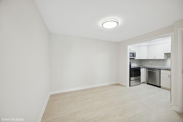 415 Wesley Ave Unit 45, Oak Park, IL 60302 - kitchen with stainless steel appliances, dark countertops, white cabinetry, and backsplash
