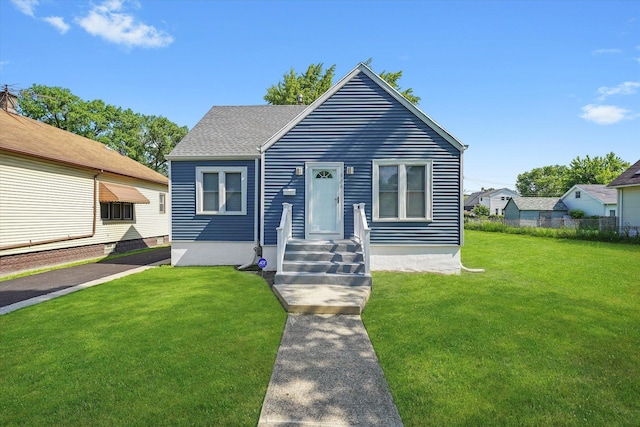 536 E 155th St, Phoenix, IL 60426 - view of front of house featuring a front lawn and a shingled roof
