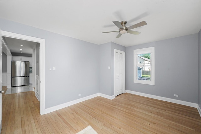 536 E 155th St, Phoenix, IL 60426 - unfurnished bedroom with freestanding refrigerator, light wood finished floors, and ceiling fan