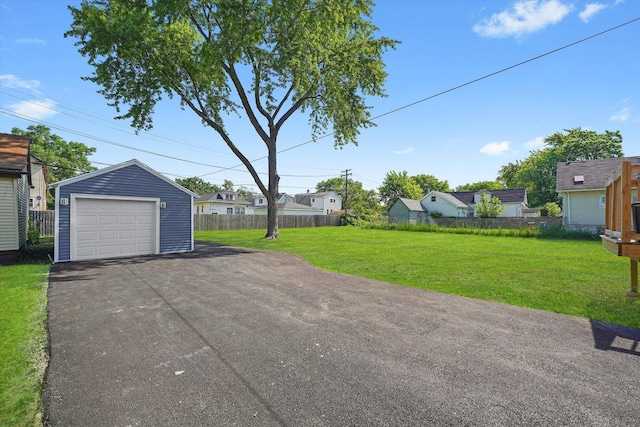 536 E 155th St, Phoenix, IL 60426 - detached garage featuring asphalt driveway and a residential view
