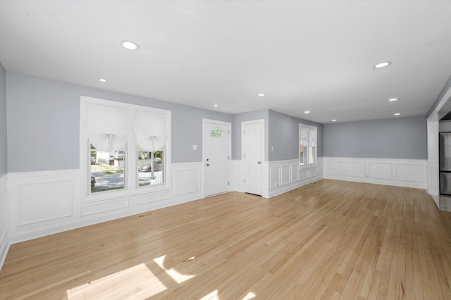 536 E 155th St, Phoenix, IL 60426 - empty room with wainscoting, light wood-style flooring, a decorative wall, and recessed lighting