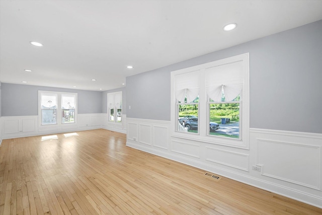 536 E 155th St, Phoenix, IL 60426 - unfurnished living room featuring wainscoting, light wood-style flooring, recessed lighting, and a decorative wall