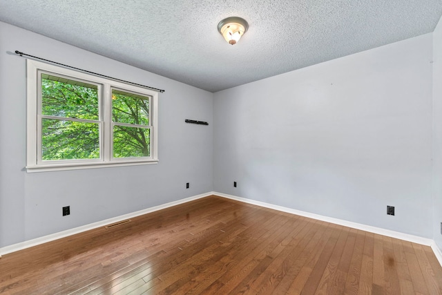 4293 W Rockton Rd, Rockton, IL 61072 - unfurnished room featuring wood-type flooring and a textured ceiling