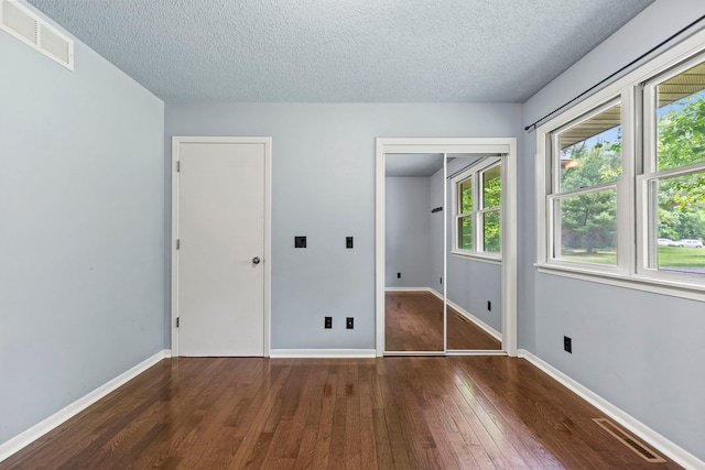 4293 W Rockton Rd, Rockton, IL 61072 - unfurnished bedroom with a textured ceiling and hardwood / wood-style floors