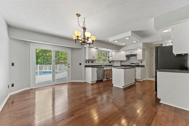 4293 W Rockton Rd, Rockton, IL 61072 - kitchen with appliances with stainless steel finishes, dark countertops, a chandelier, a textured ceiling, and white cabinets