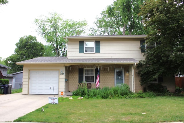 1254 Blackhawk Dr, Elgin, IL 60120 - traditional home with a garage, brick siding, concrete driveway, and a front lawn