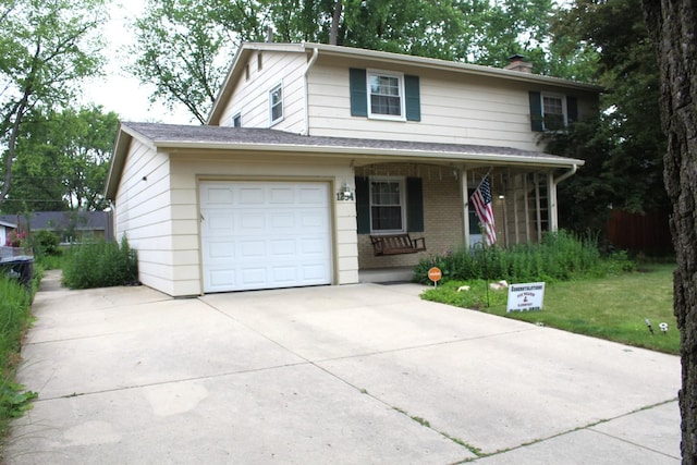 1254 Blackhawk Dr, Elgin, IL 60120 - view of front of house with driveway, a chimney, covered porch, a garage, and brick siding