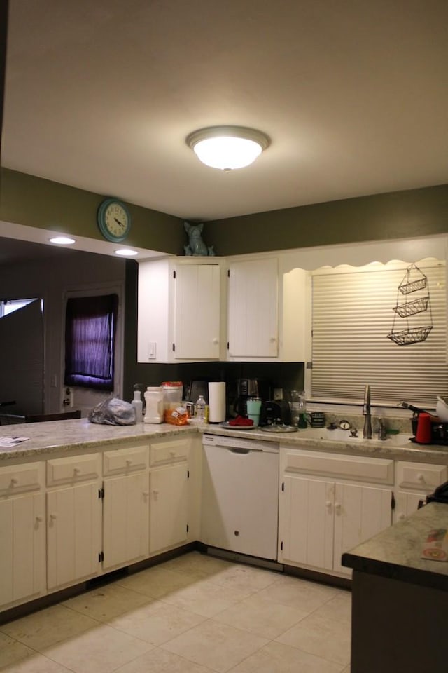 1254 Blackhawk Dr, Elgin, IL 60120 - kitchen featuring white dishwasher, white cabinetry, light countertops, and light tile patterned floors