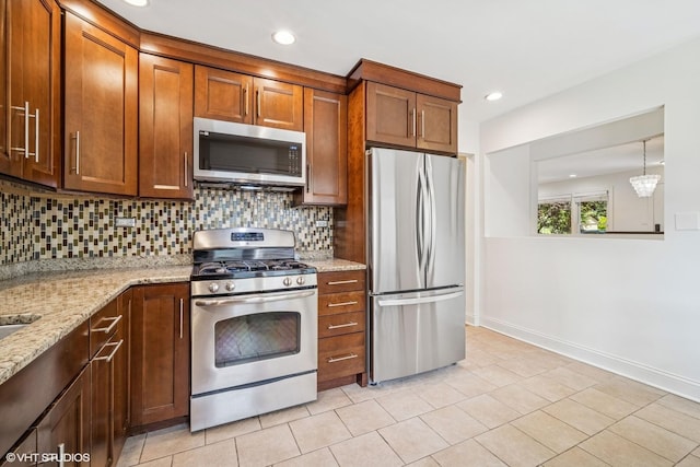 630 Wesley Dr, Park Ridge, IL 60068 - kitchen with stainless steel appliances, tasteful backsplash, light tile patterned floors, brown cabinetry, and recessed lighting