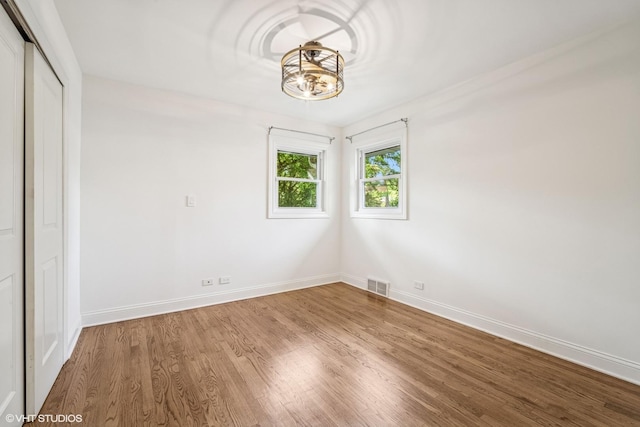 630 Wesley Dr, Park Ridge, IL 60068 - spare room featuring wood finished floors and a chandelier